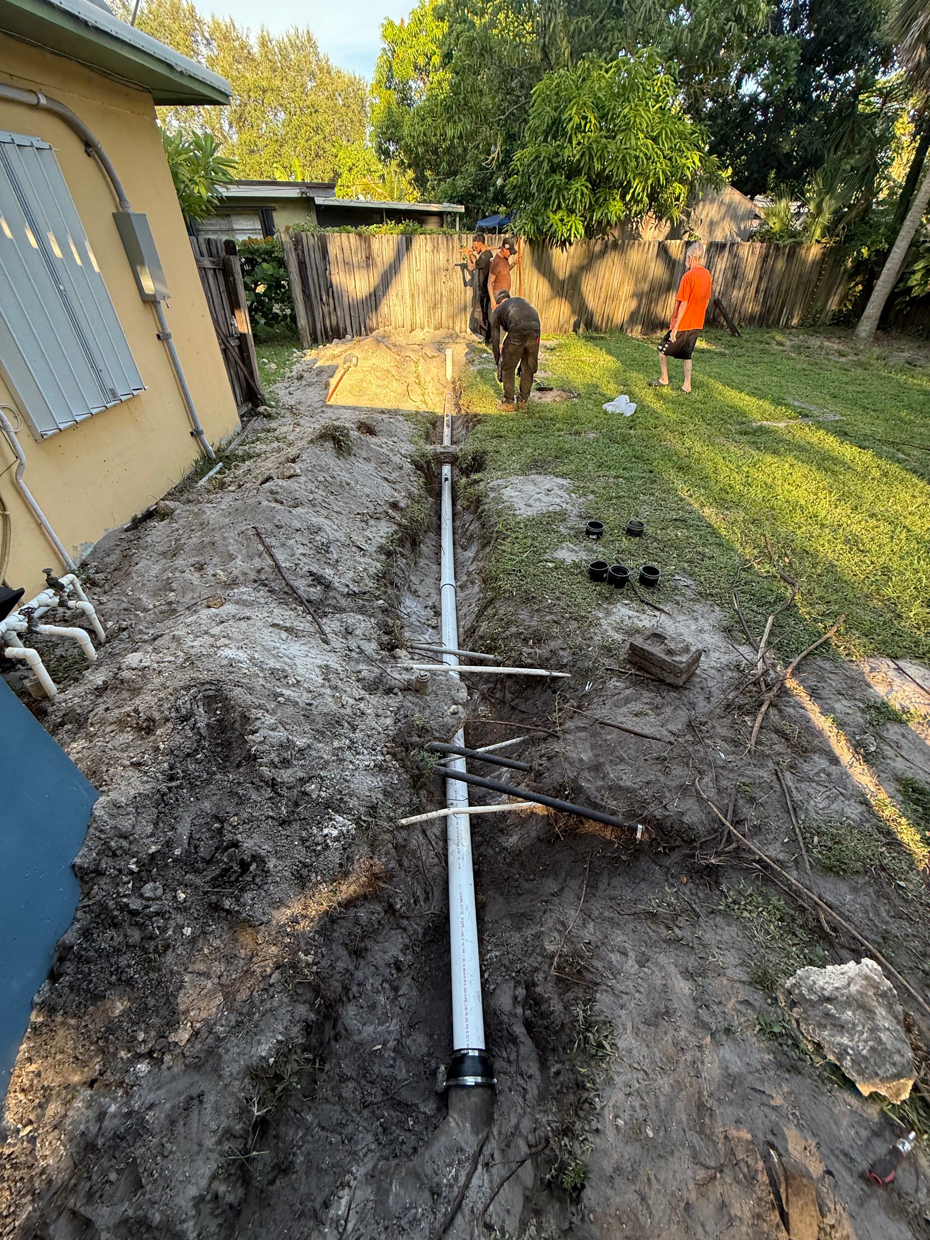 Professional septic system installation in residential backyard